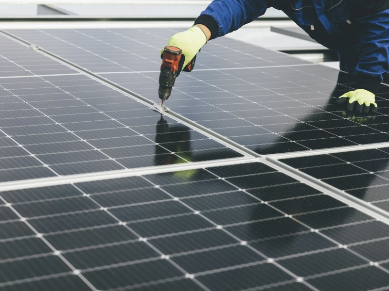 Technician working on a solar panel array